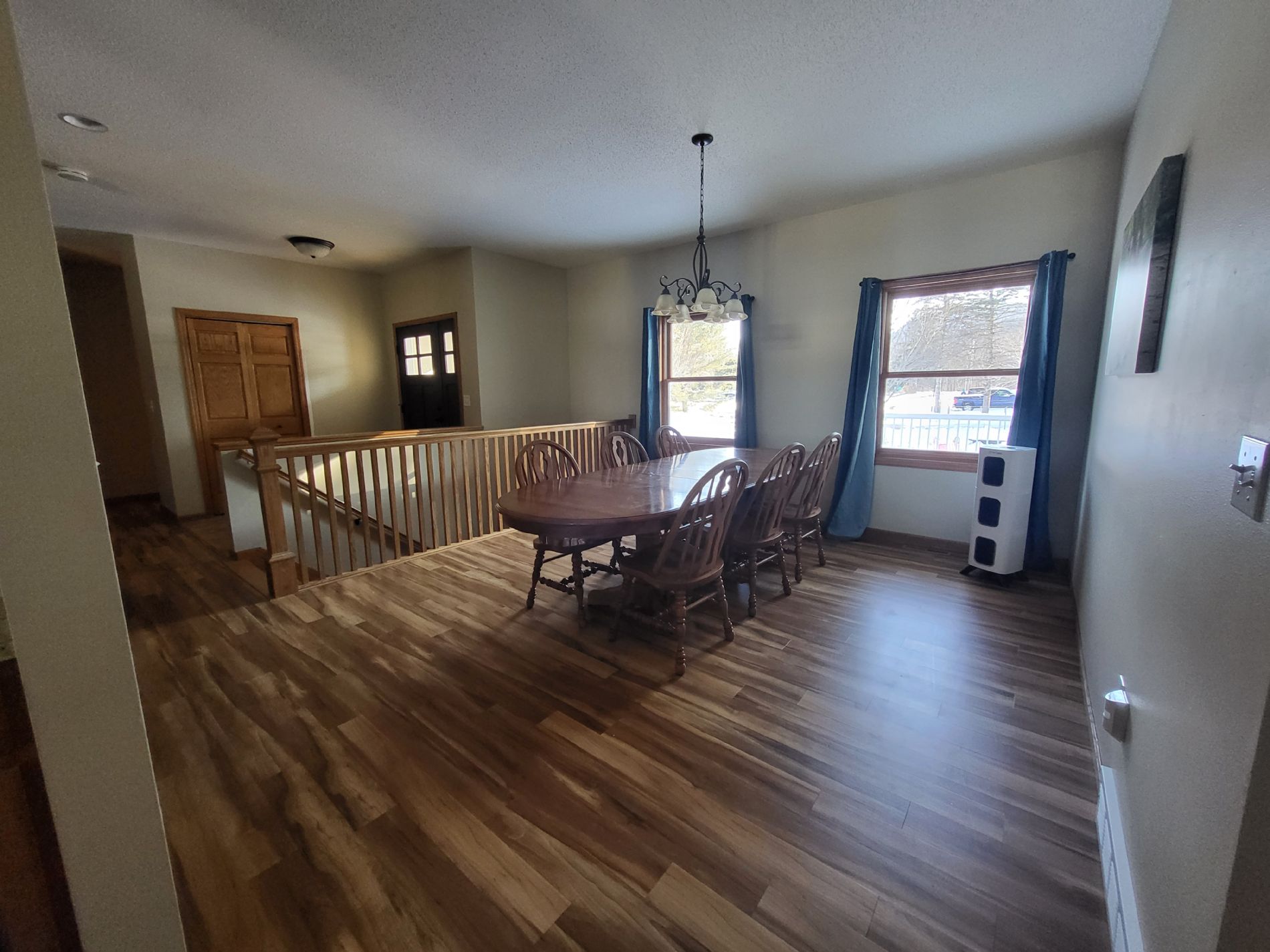 Gigantic dining room with outside views, staircase leading to the finished basement, and entrance.