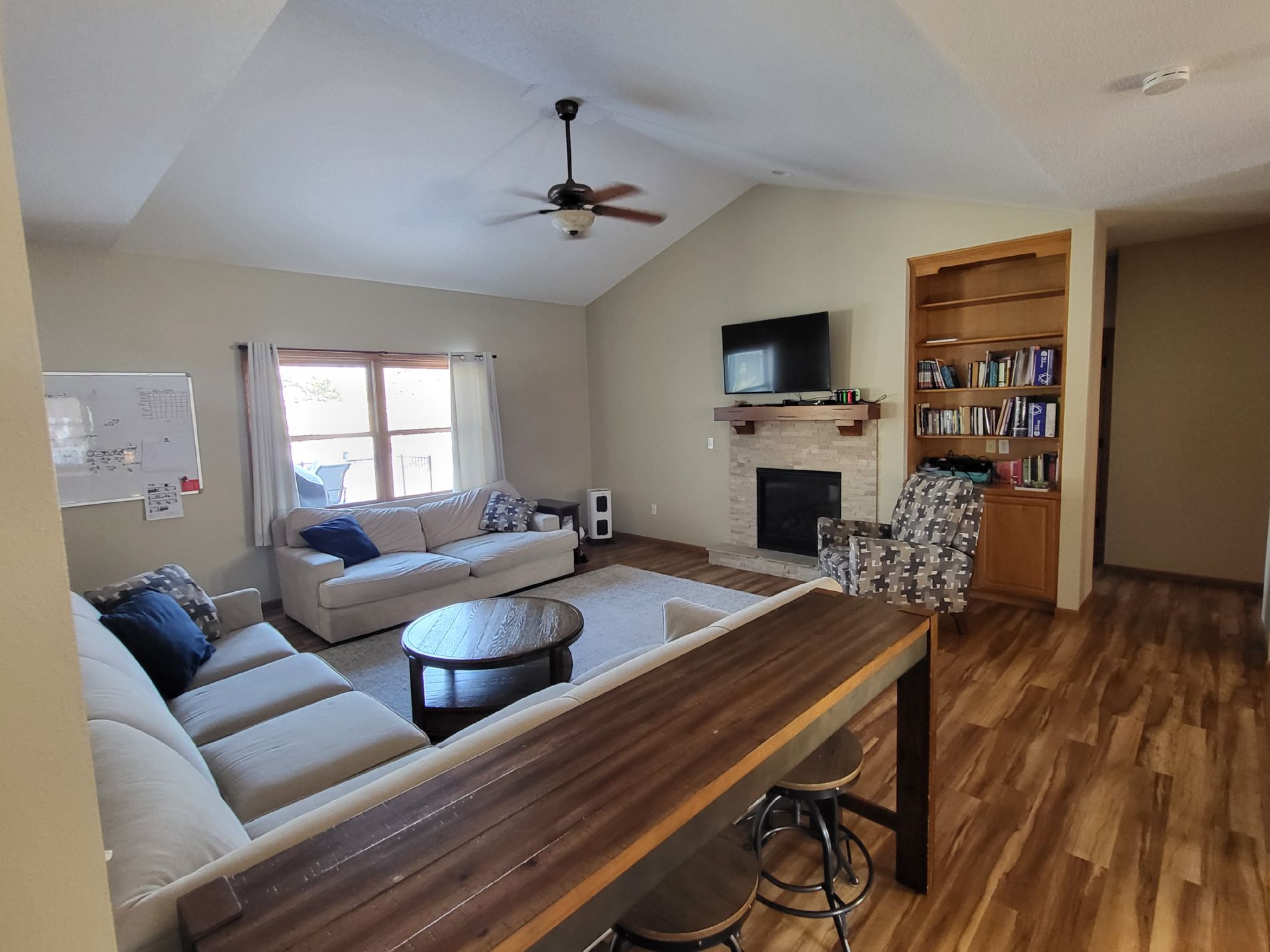 Great room with vaulted ceilings, fireplace and built-in oak bookcase.
