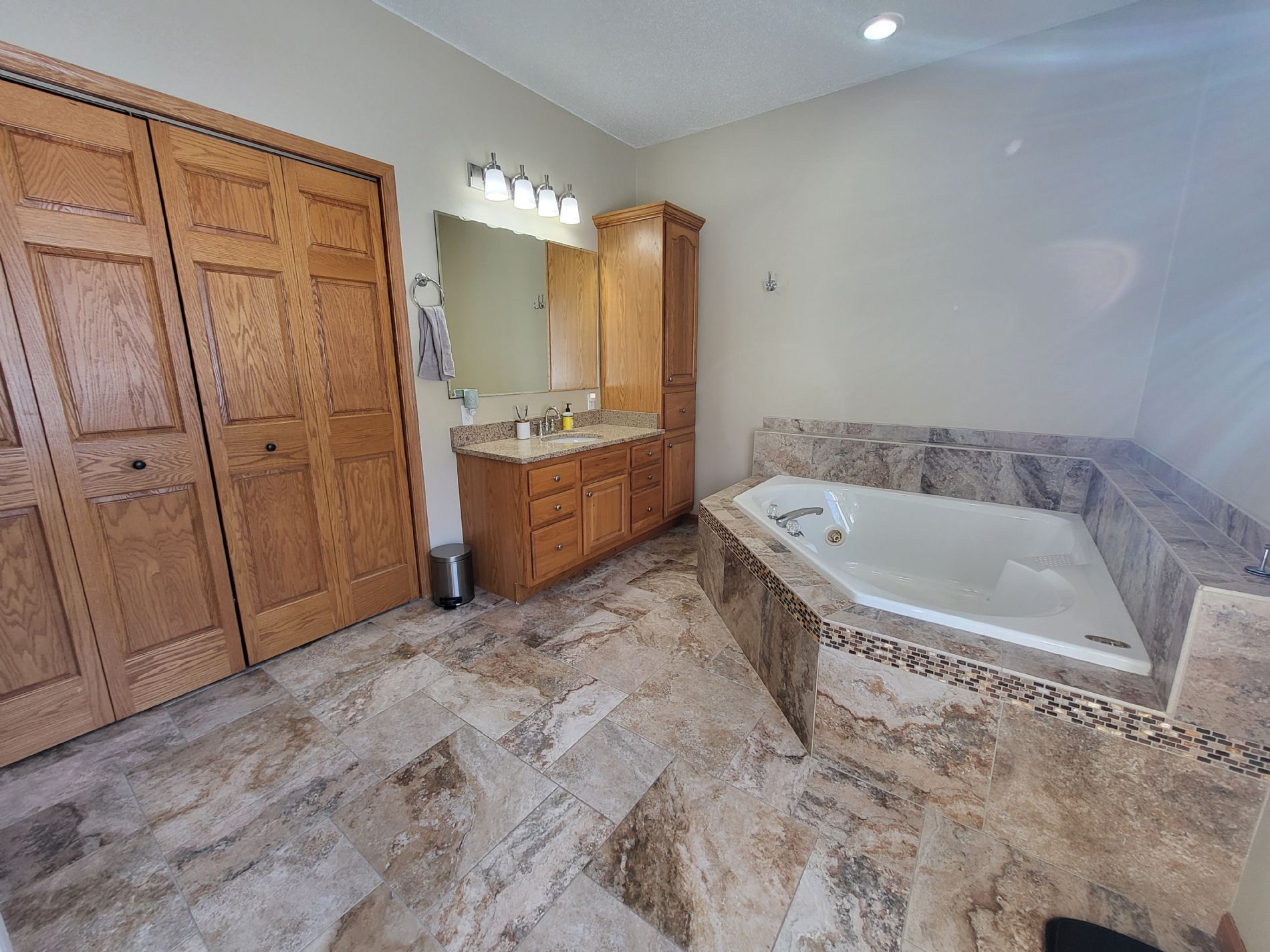Master bath with jetted tub, master closet, heated floor, and separate shower