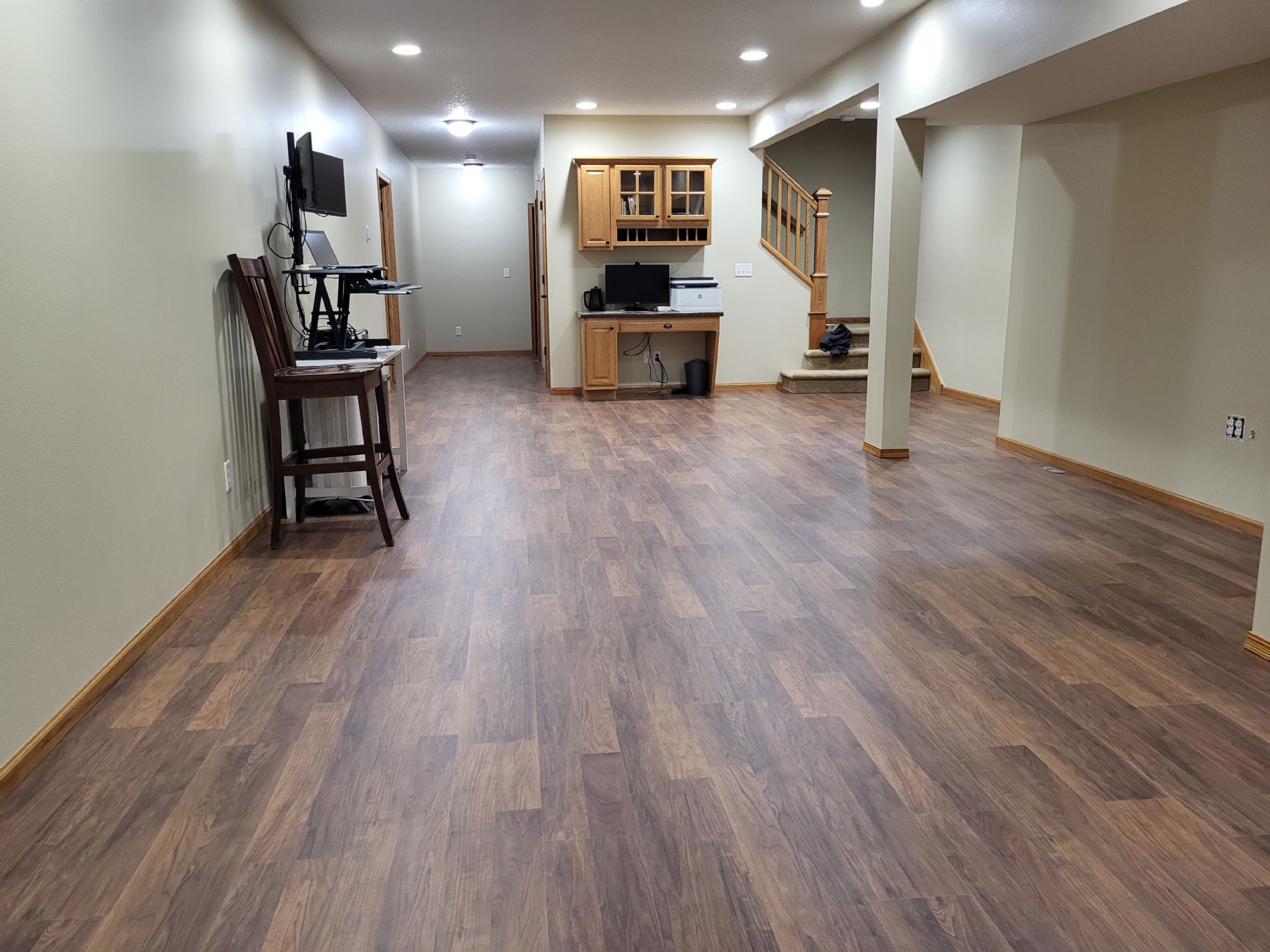 Huge downstairs media/craft/hobby/tv room with built-in oak desk.