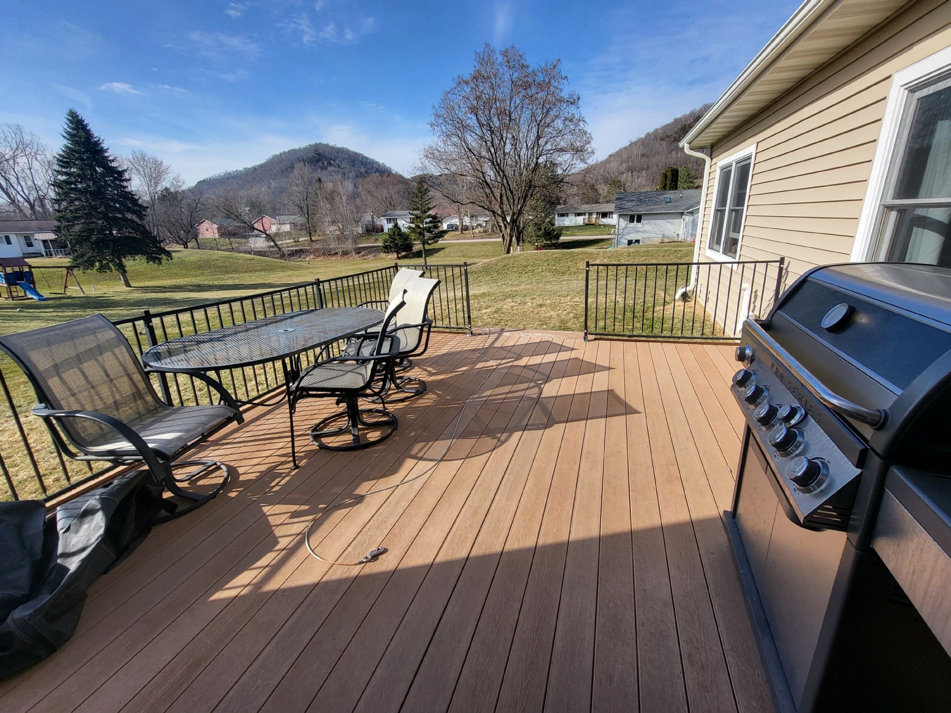 Backyard composite porch with scenic views, room for grilling, and entertaining.